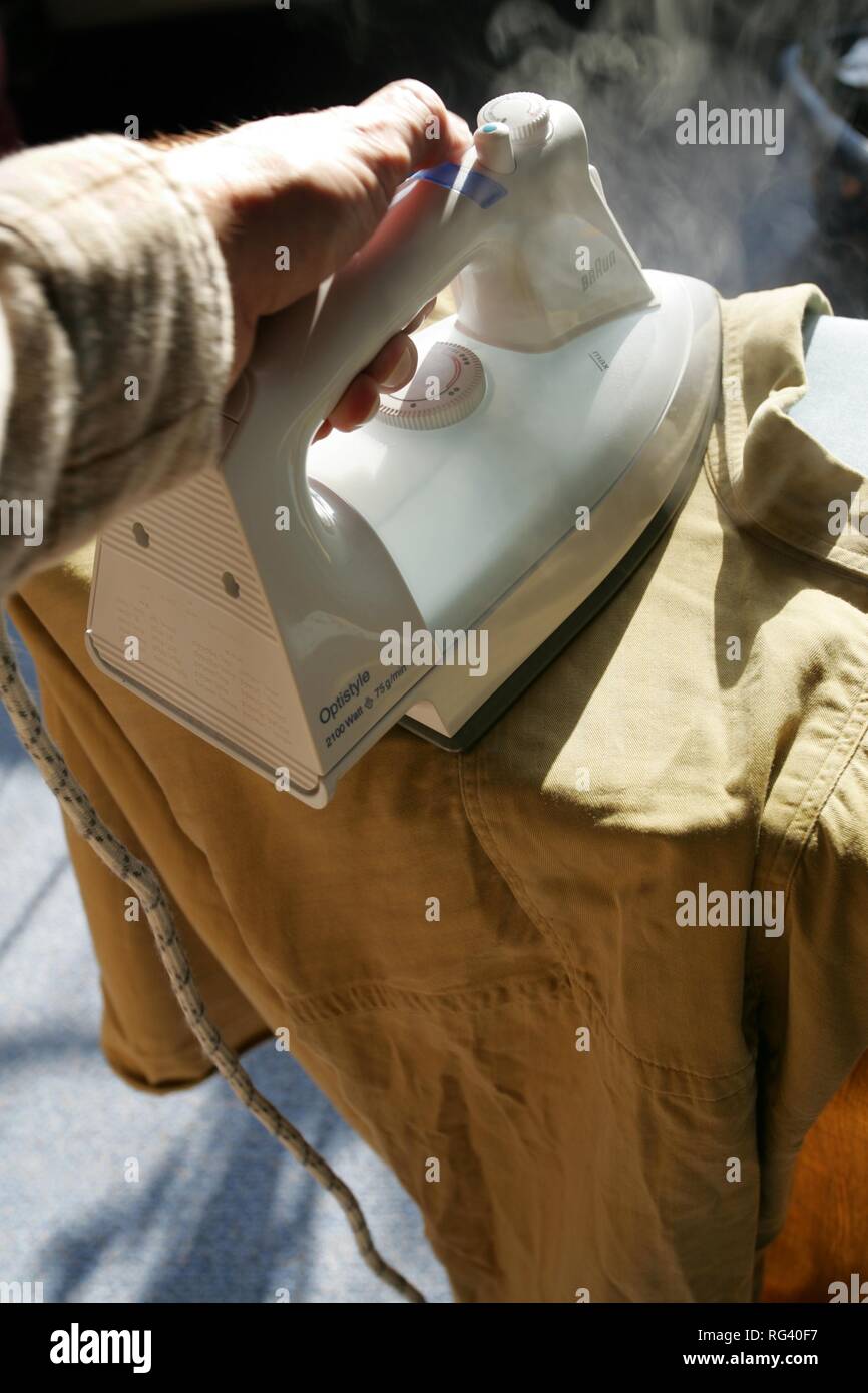 DEU, Germany : Iron of laundry at home. Steam iron. Stock Photo