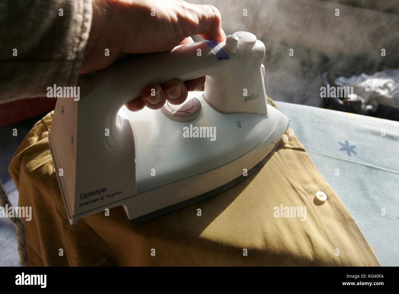 DEU, Germany : Iron of laundry at home. Steam iron. Stock Photo