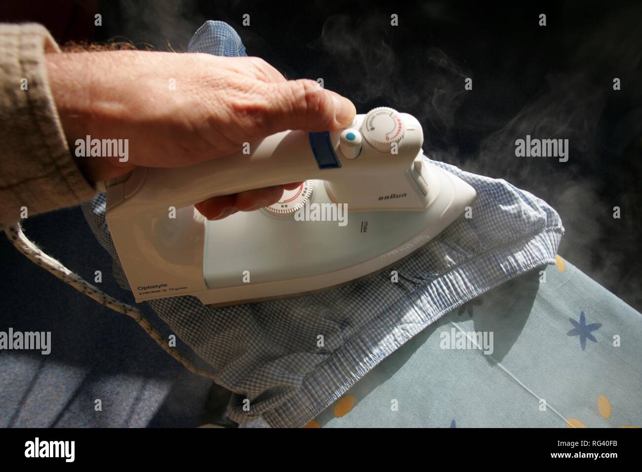 DEU, Germany : Iron of laundry at home. Steam iron. Stock Photo