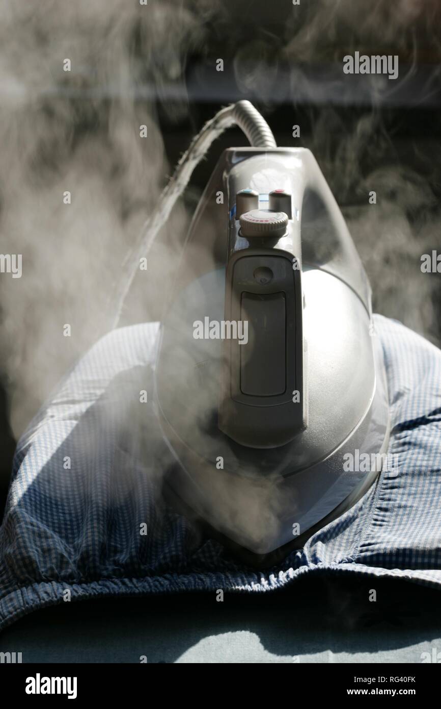 DEU, Germany : Iron of laundry at home. Steam iron. Stock Photo
