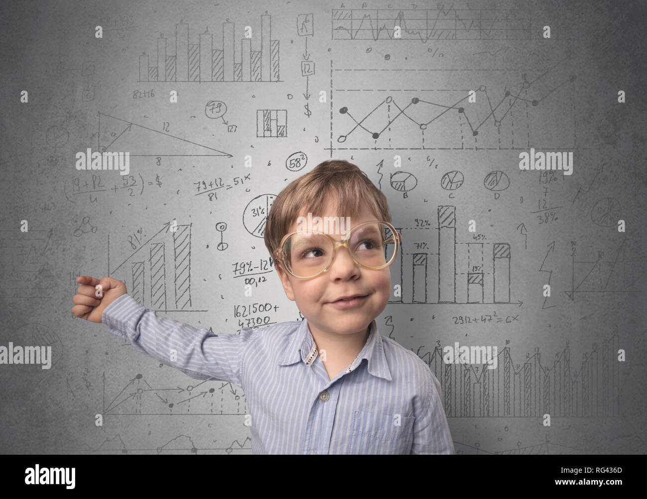 Little boy in front of a grey wall with graphs and statistics around ...
