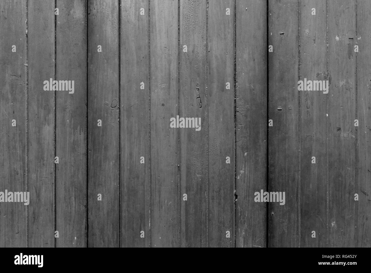 Full frame background of an old, faded and dirty wood board wall in black and white. Stock Photo