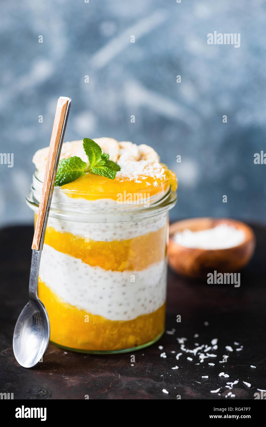 Layered Vegan Chia Pudding With Mango in Jar. Concept of healthy eating