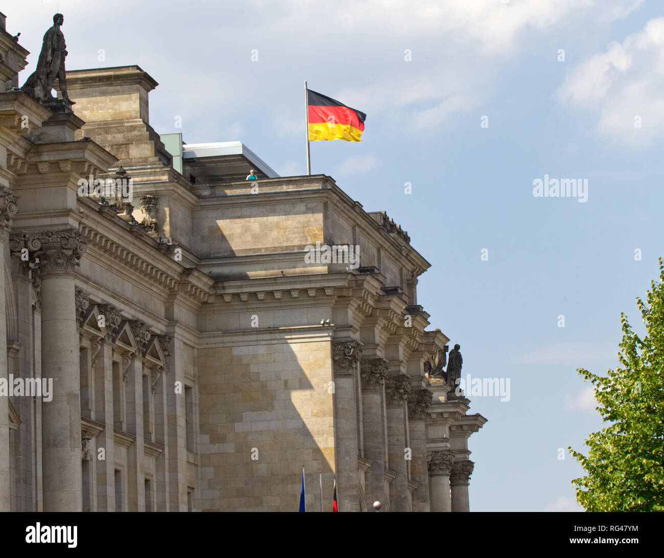 July 5, 2018- Berlin, Germany: A german flag flies atop the historic edifice of the Reichstag building in Germany Stock Photo