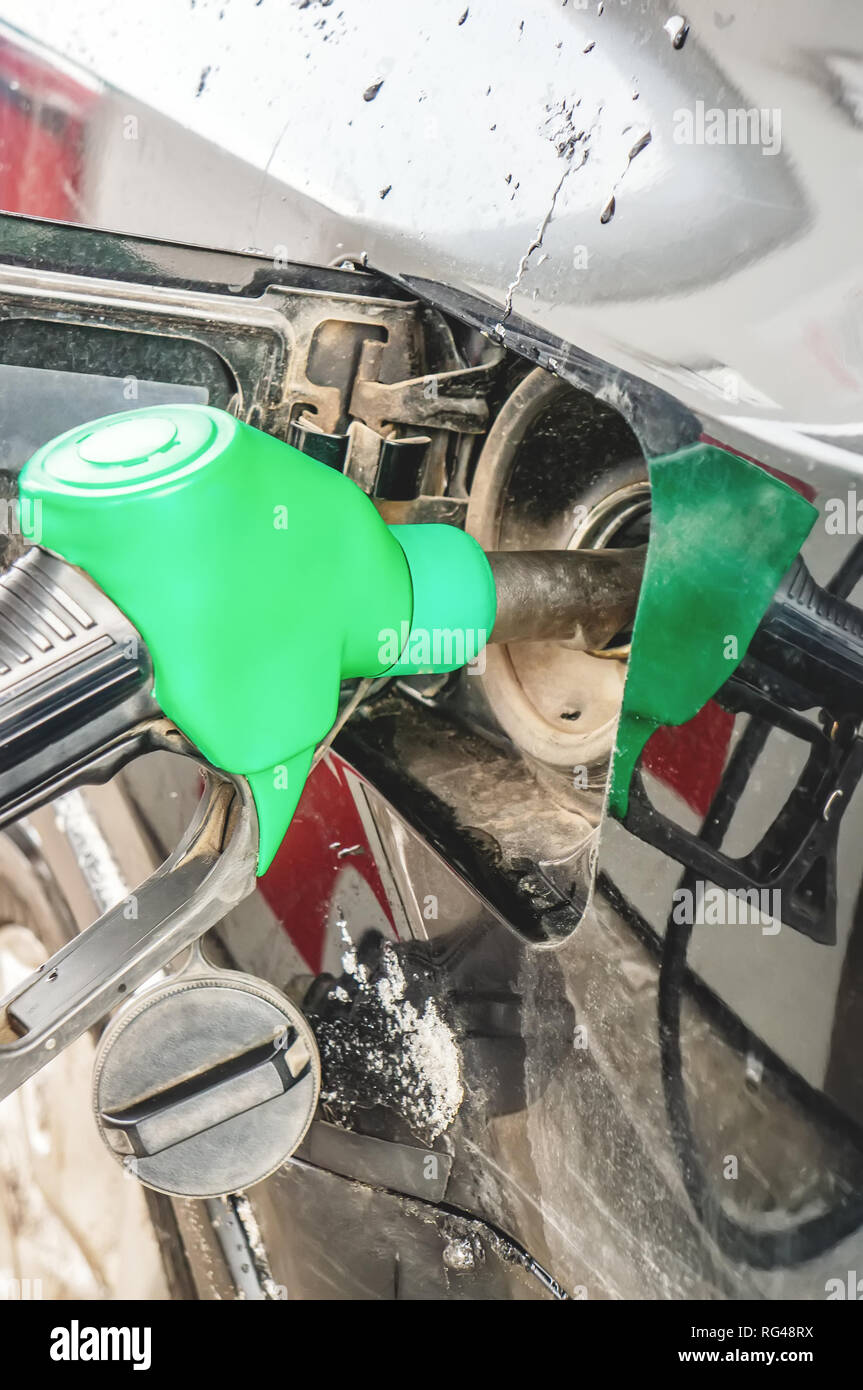 Man fills the gas tank of the car. The concept of price changes for