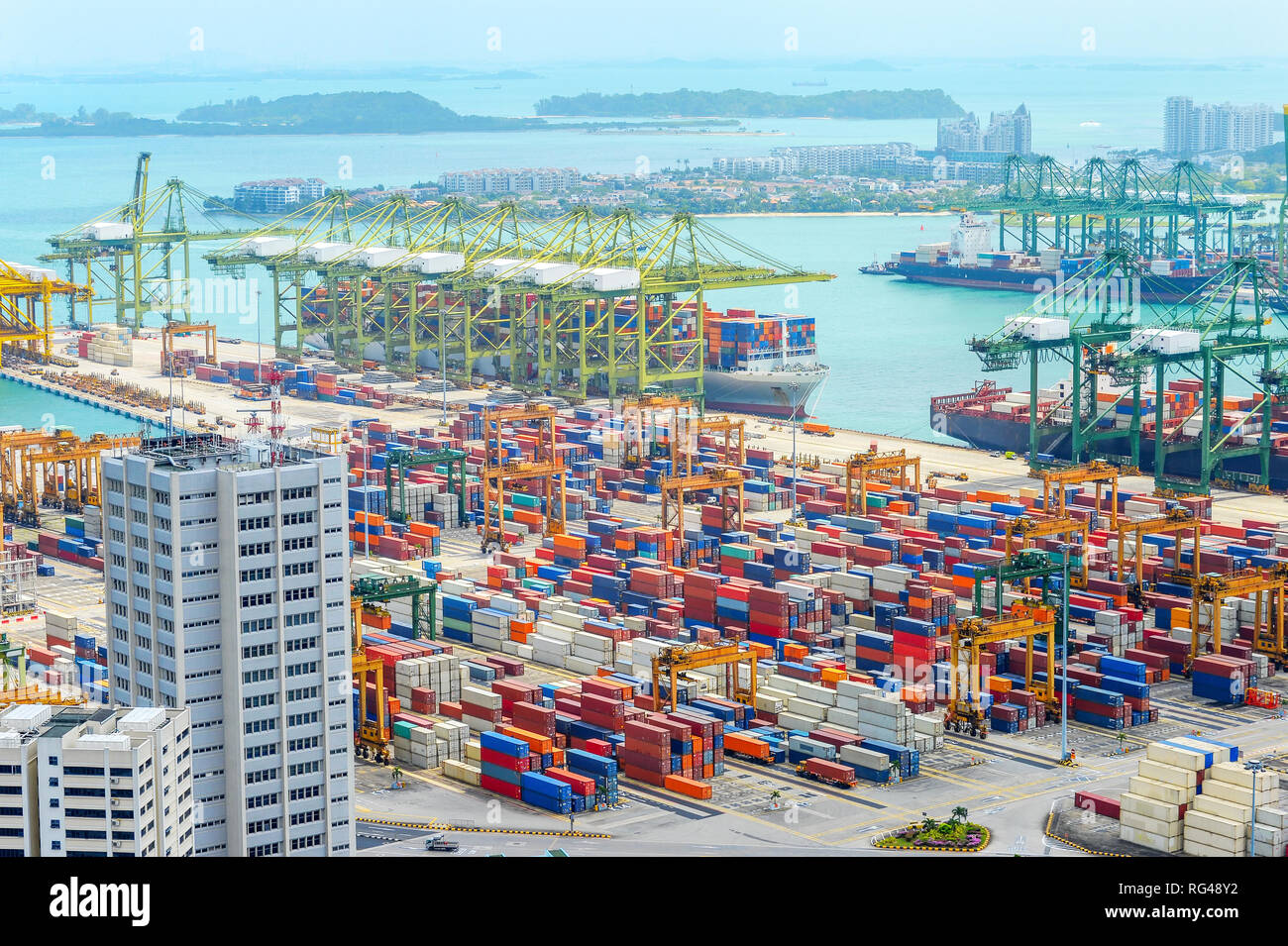 Aerial view of Singapore harbor with commercial port full of freight containers, cargo ships and