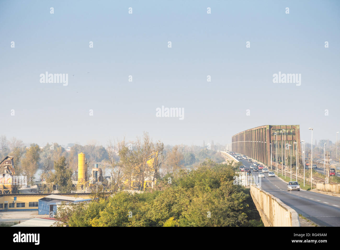 BELGRADE, SERBIA - AUGUST 2, 2015: Dense car traffic passing by the Pancevacki Most, or Pancevo bridge, during a day of bad atmospheric air quality wi Stock Photo
