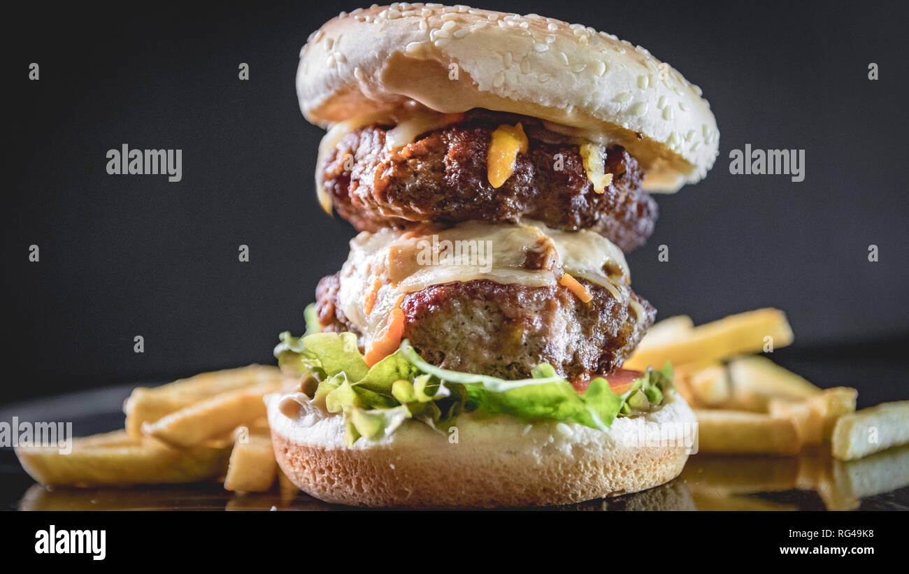 Double cheese burger with mayo and fries Stock Photo