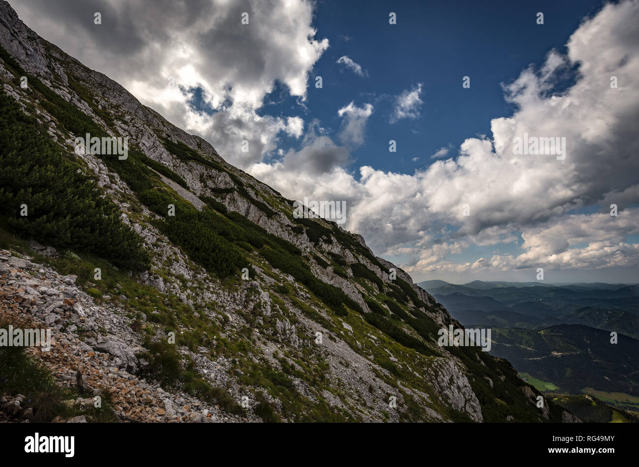 Scenic view on rocky route Nandsteig from Puchberg to Kaiserstein on Rax  plateau, Schneeberg masif with dramatic cloudy sky and pine trees, Raxalpe,  L Stock Photo - Alamy