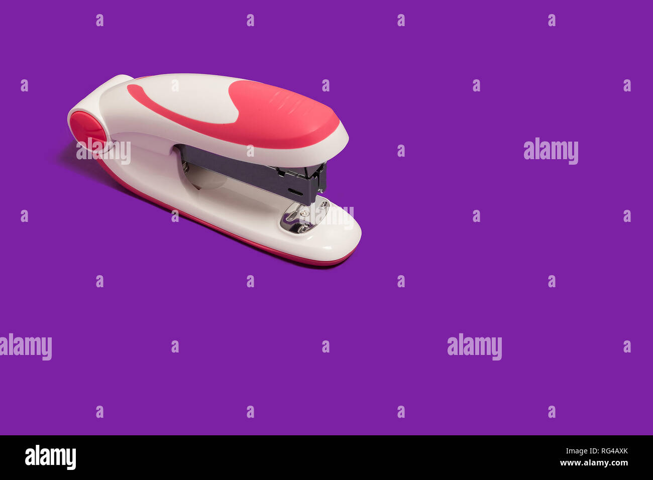 stapler on a purple surface Stock Photo