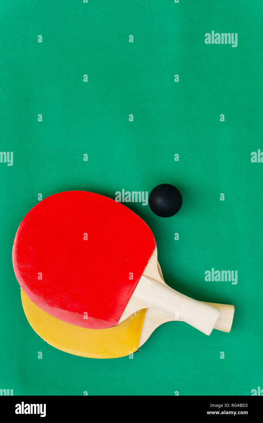 Red and yellow table tennis rackets with black balls, table tennis