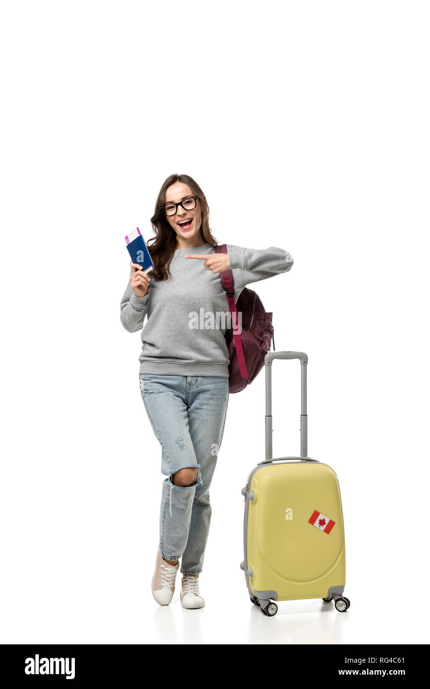 female student with suitcase pointing with finger at passport and air  tickets isolated on white, studying abroad concept Stock Photo - Alamy