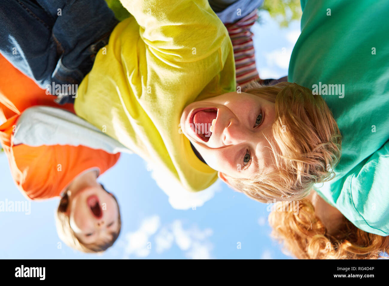 Group of kids is kidding and making faces together in kindergarten Stock Photo