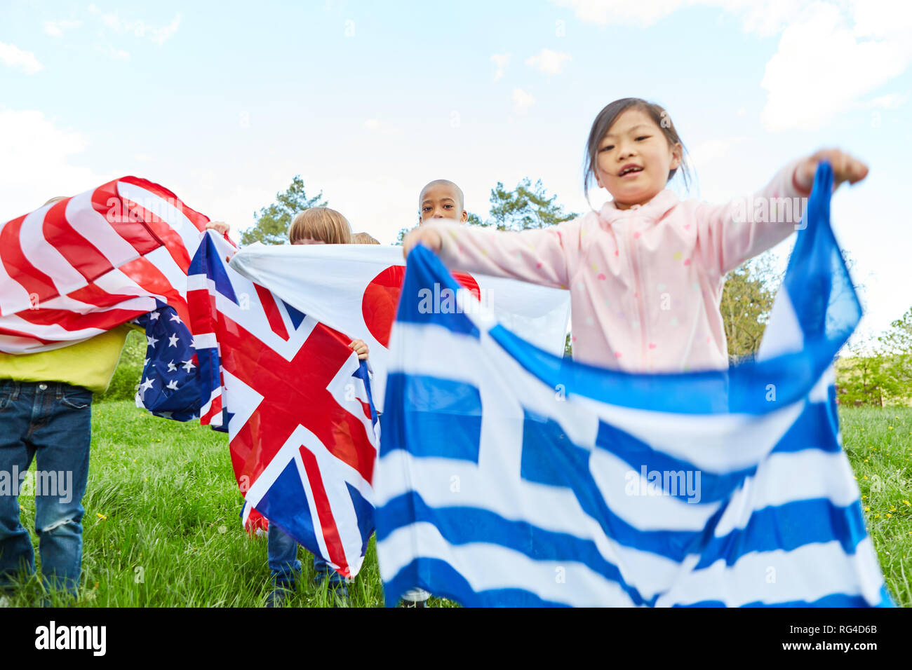 Children show national flags as a symbol of diversity and international understanding Stock Photo