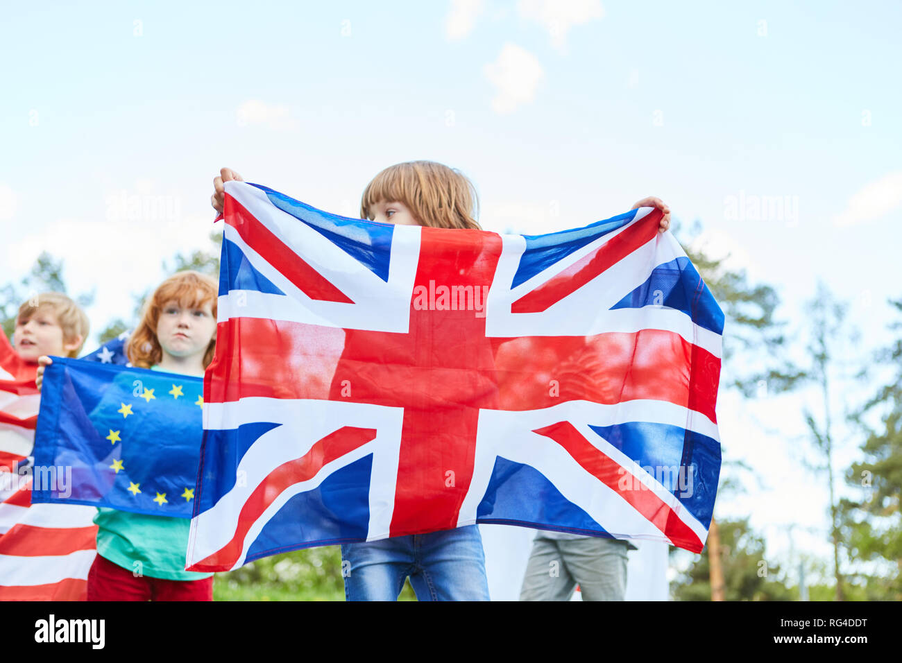 Children in international youth camp with the flags of Great Britain and Europe Stock Photo