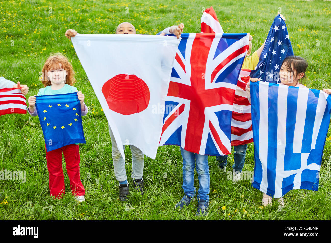 Children in international kindergarten with national flags as a symbol of diversity Stock Photo