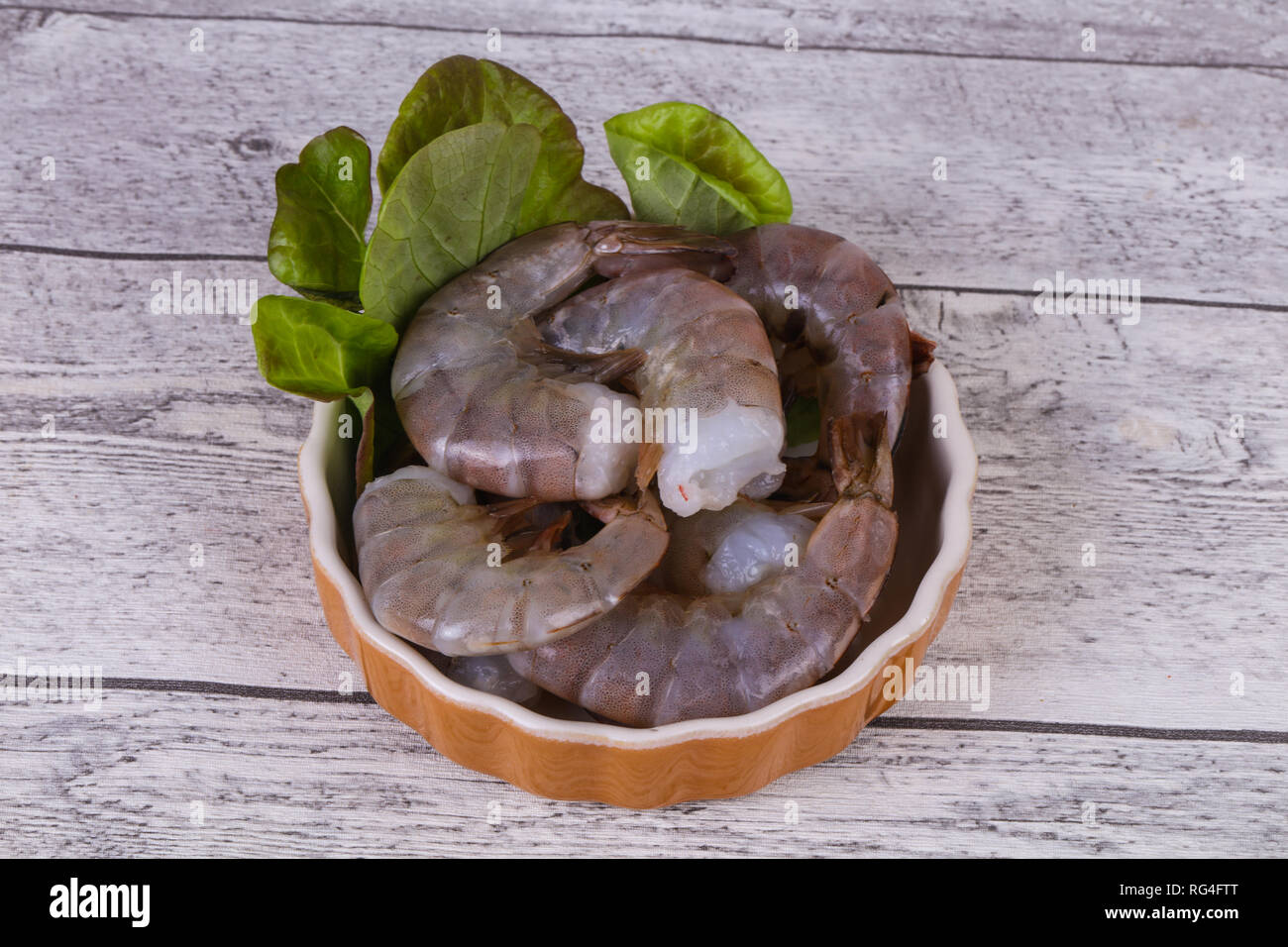 Raw king prawns ready for cooking served salad leaves Stock Photo Alamy