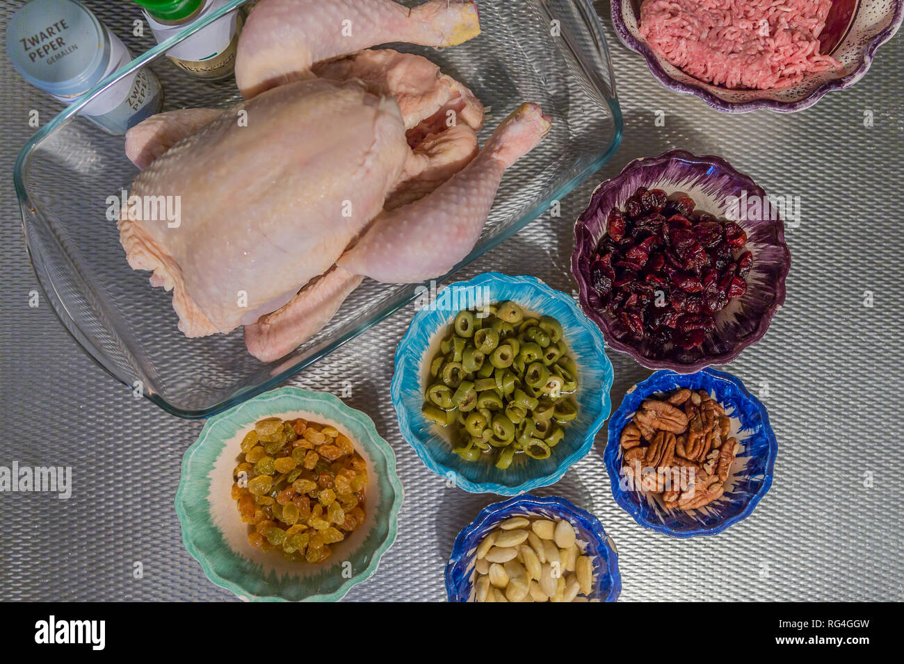 image of a raw whole chicken and stuffing ingredients, ground beef
