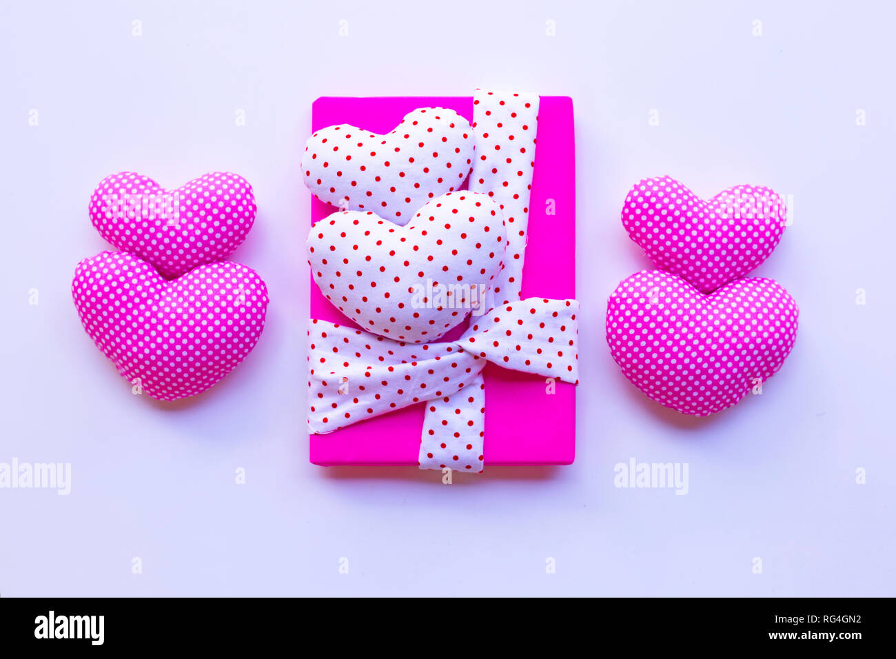 Gift box with Valentine's hearts on pink background. Top view Stock Photo