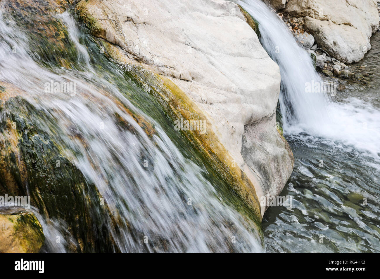 Close-up small waterfall on a stone mountain river. Stock Photo