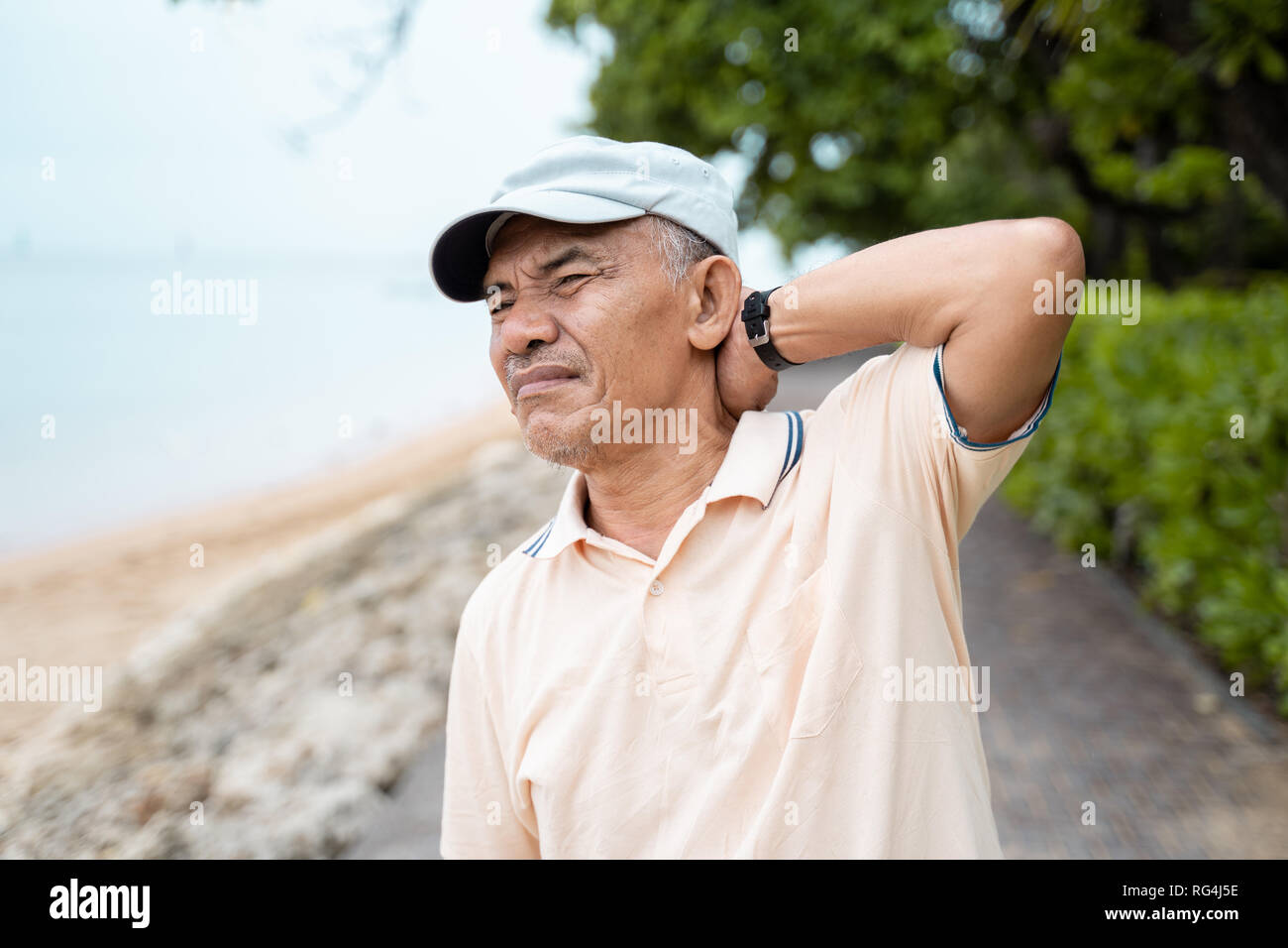 senior male having neck pain Stock Photo