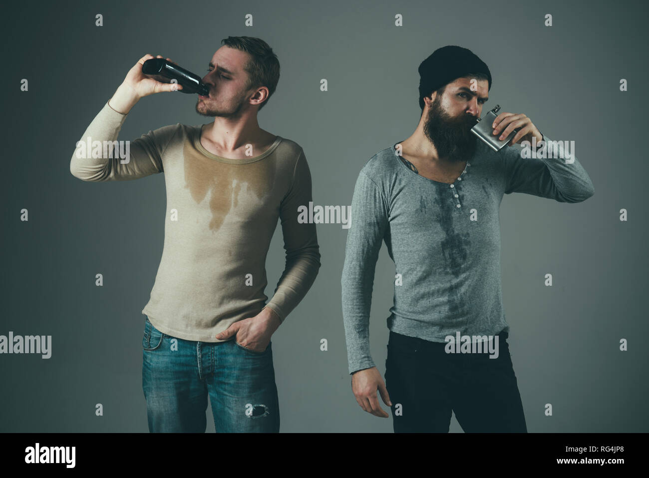 Bad habits. Men drinking alcohol from bottle and flask. Alcoholics
