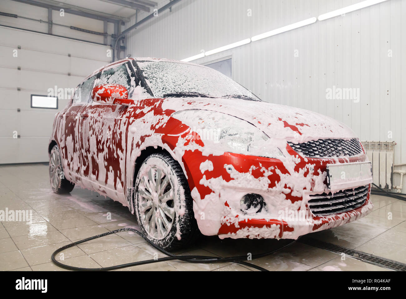 Car washing concept. Red car in foam Stock Photo - Alamy