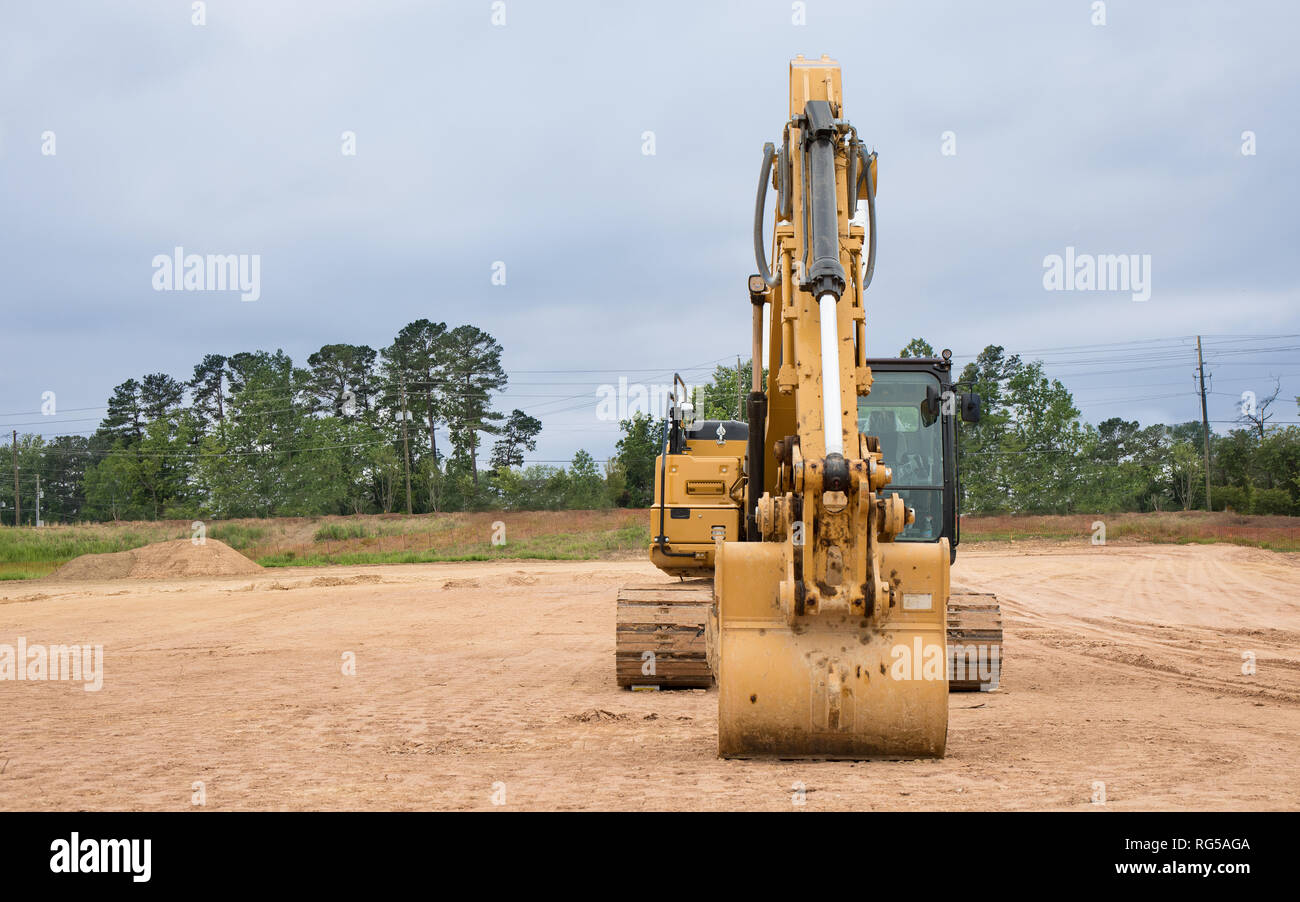 An excavator sitting at a construction site Stock Photo - Alamy