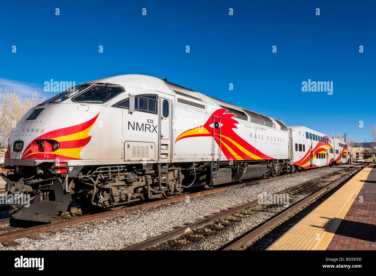 New Mexico Rail Runner Express commuter train and railroad tracks, parked in Santa Fe, New Mexico, USA. Stock Photo