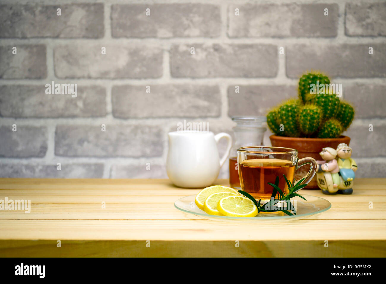 Red tea and lemon slice on pine wood table with copy space in teatime concept, bakery shop, food and beverage product display concept or co-working sp Stock Photo