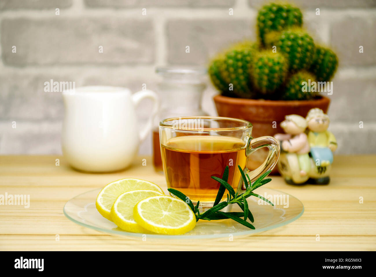 Red tea and lemon slice on pine wood table. Stock Photo