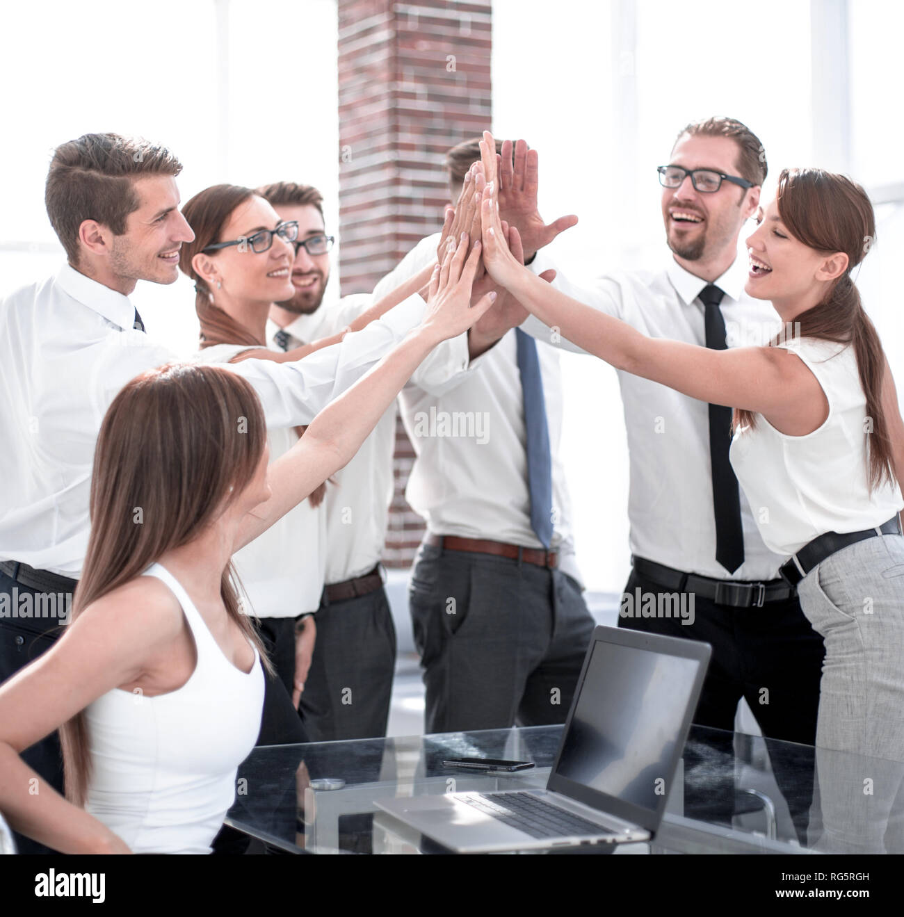 young business team giving each other high five Stock Photo - Alamy