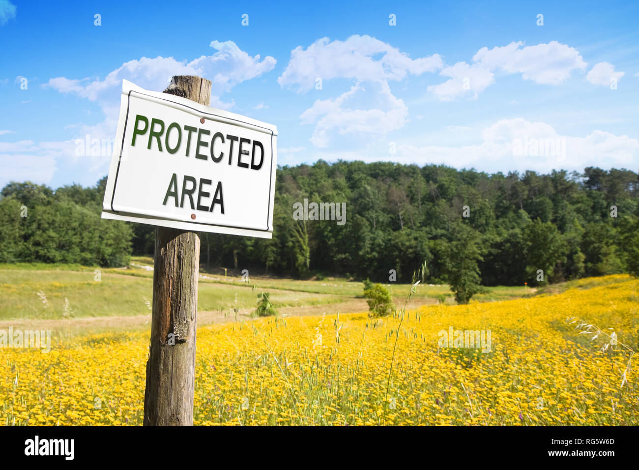 'Protected area' written on a field sign - Sign indicating in the countryside - image with copy space Stock Photo