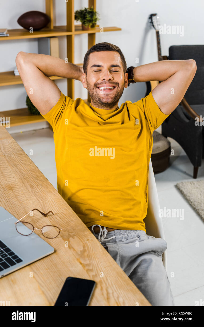 Smiling teleworker sitting on hi-res stock photography and images - Alamy