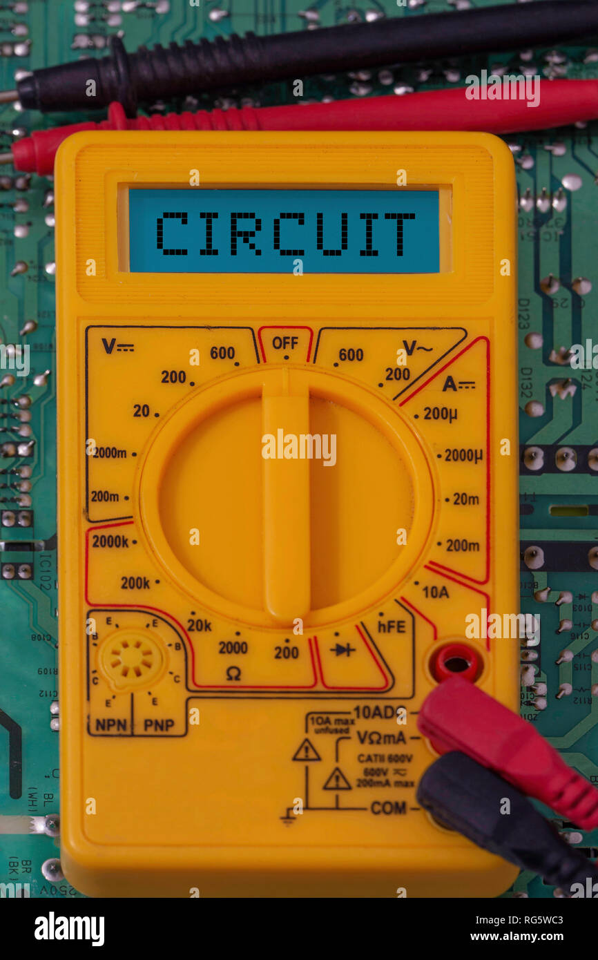 Digital multimeter multitester on a circuit board with the word circuit