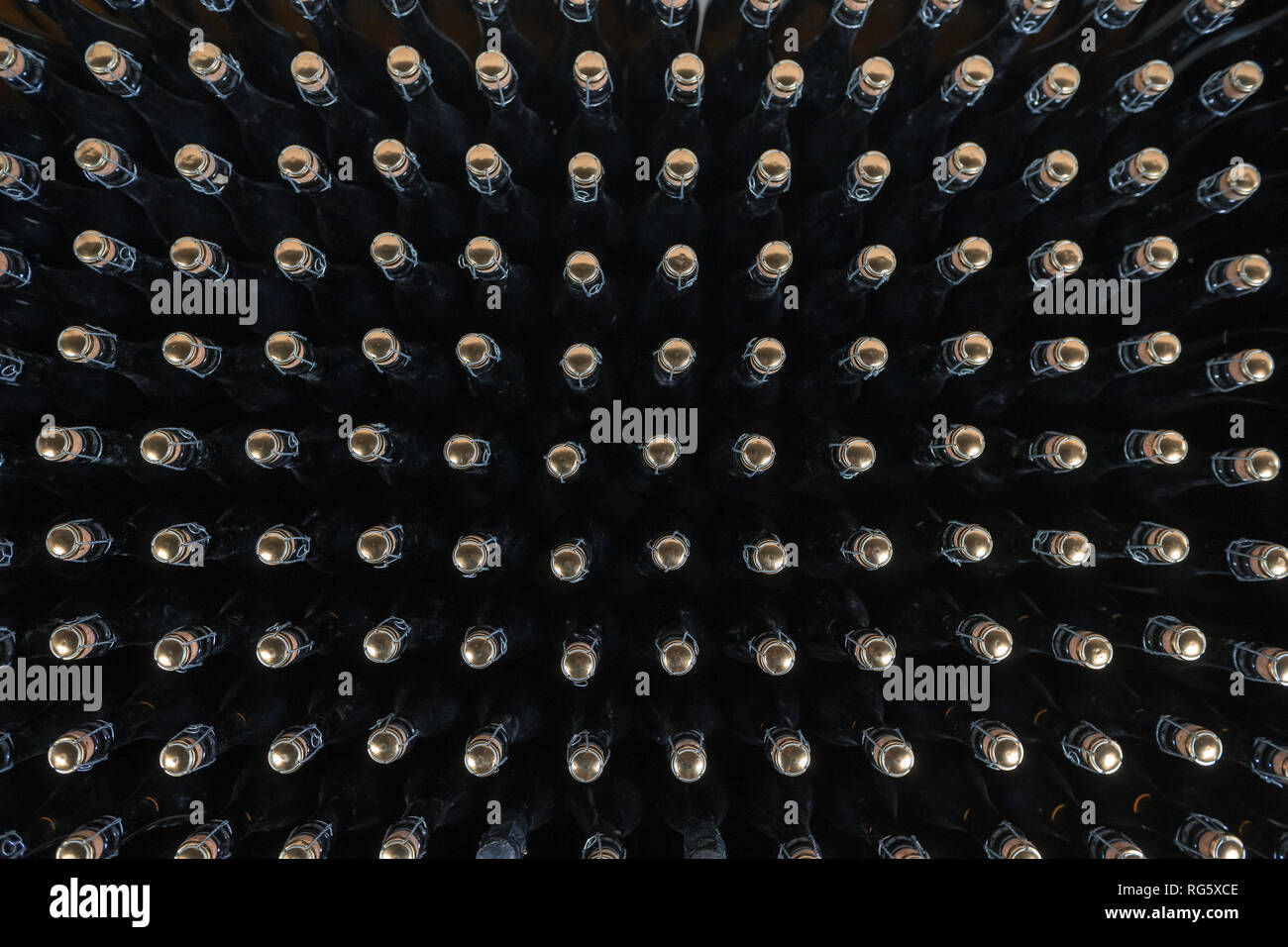 Pattern of sparkling wine bottles seen from above Stock Photo