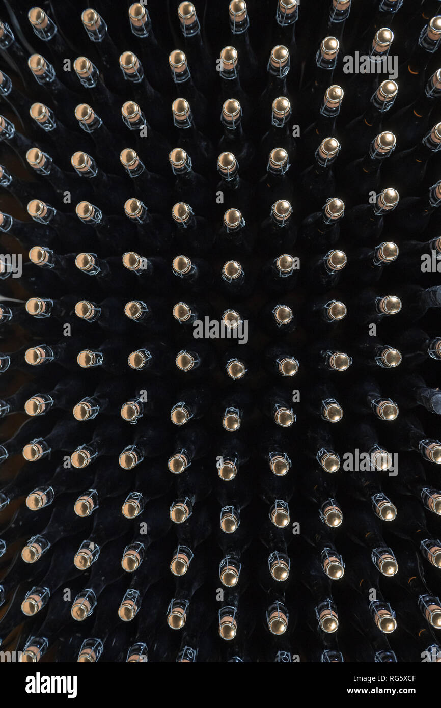 Pattern of sparkling wine bottles seen from above Stock Photo