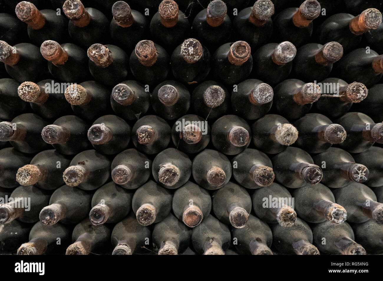 Wine bottles pattern stacked in winery Stock Photo