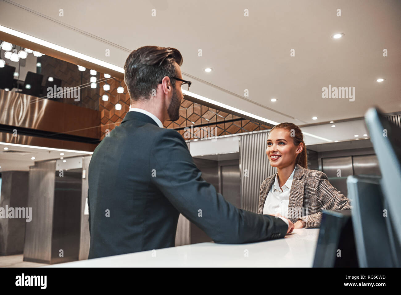 Nice Meeting At Hotel Close Up Of Couple On A Business Trip Doing Check In At The Hotel Man And Woman Are Looking At Each Other Stock Photo Alamy