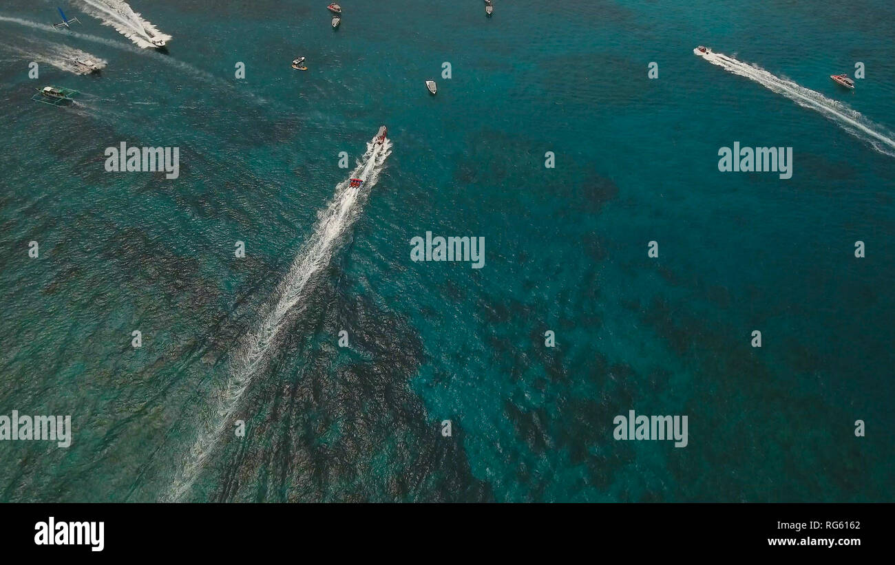 People having fun on banana boat. Group of people riding banana boat