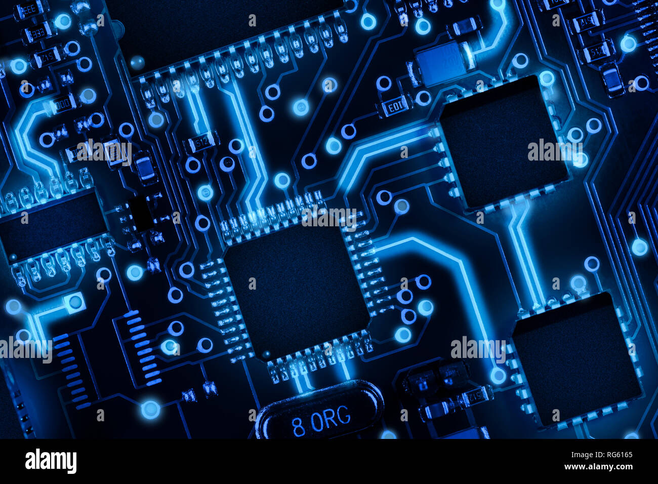 Printed circuit board with components, with highlighted connections between each element. Abstract high tech background. Stock Photo