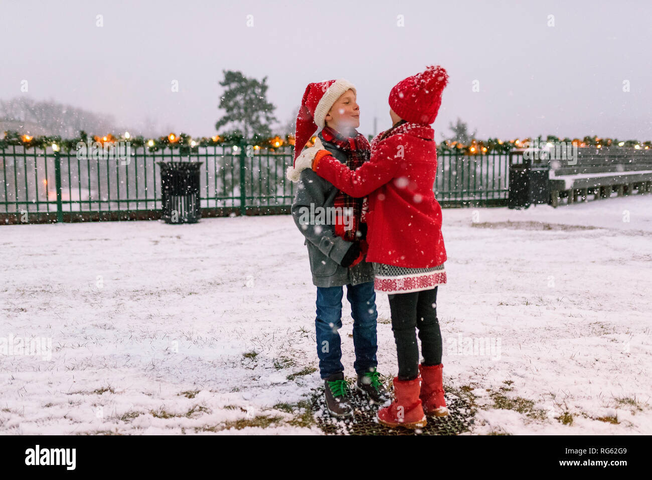 Two children standing in the snow playing, United States Stock Photo