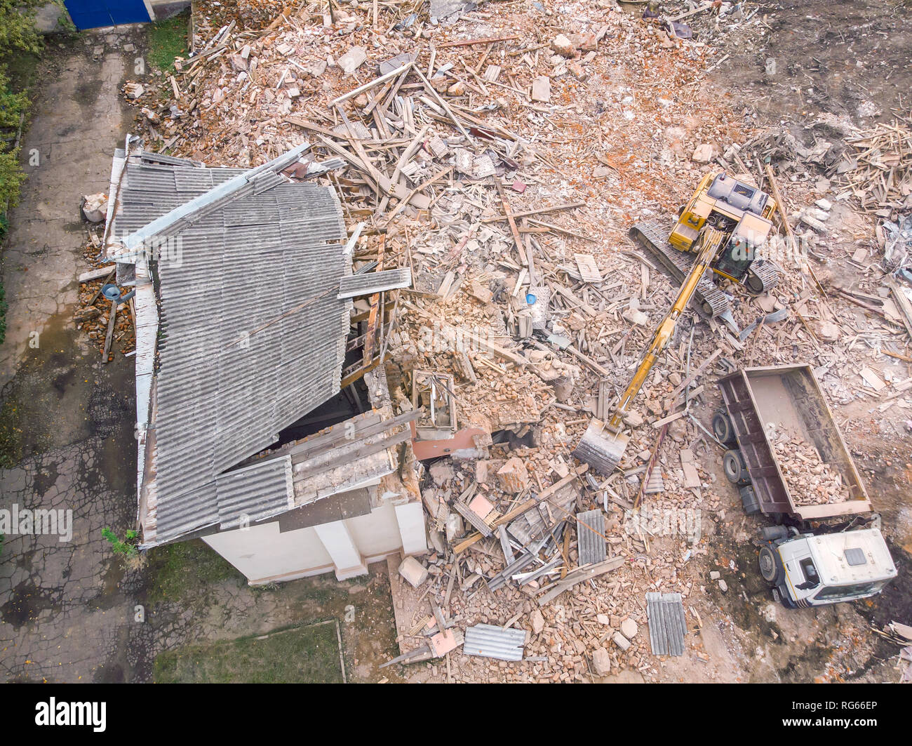 heavy construction machinery clearing out demolition site. aerial top view Stock Photo