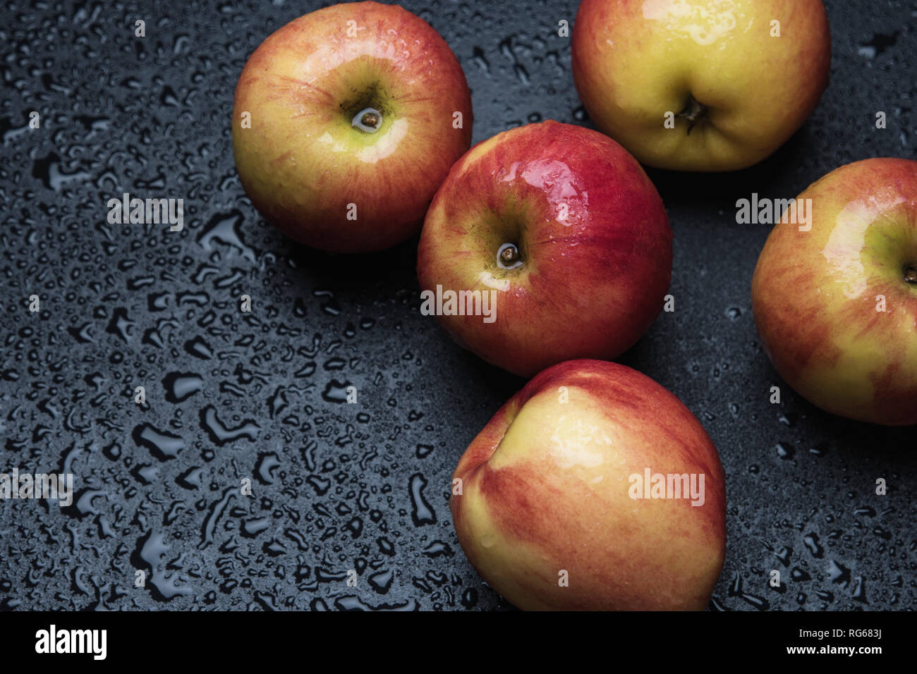 Organic apples on wet floor Stock Photo