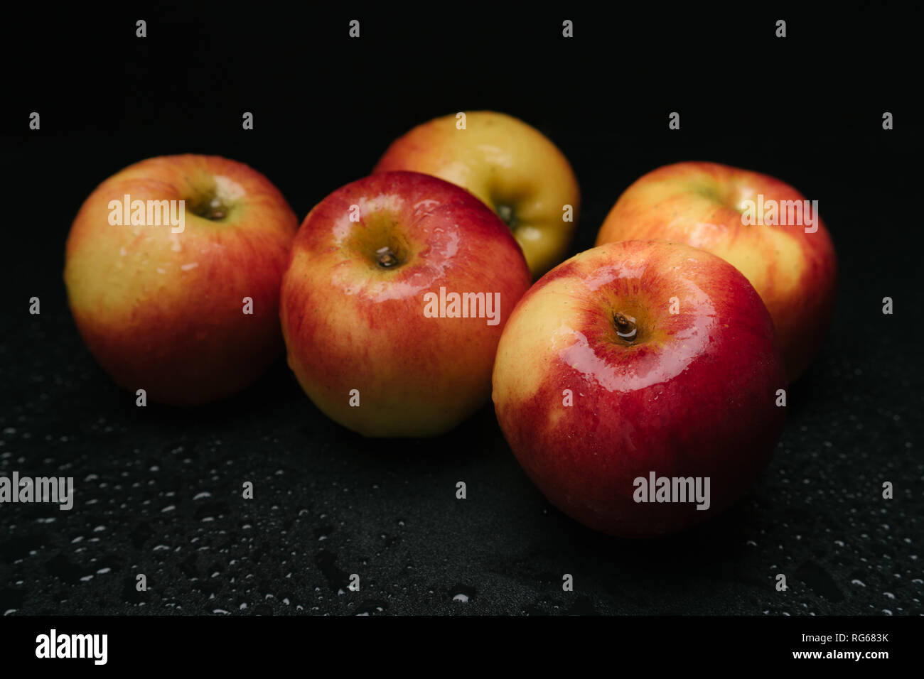 Organic apples on wet floor Stock Photo