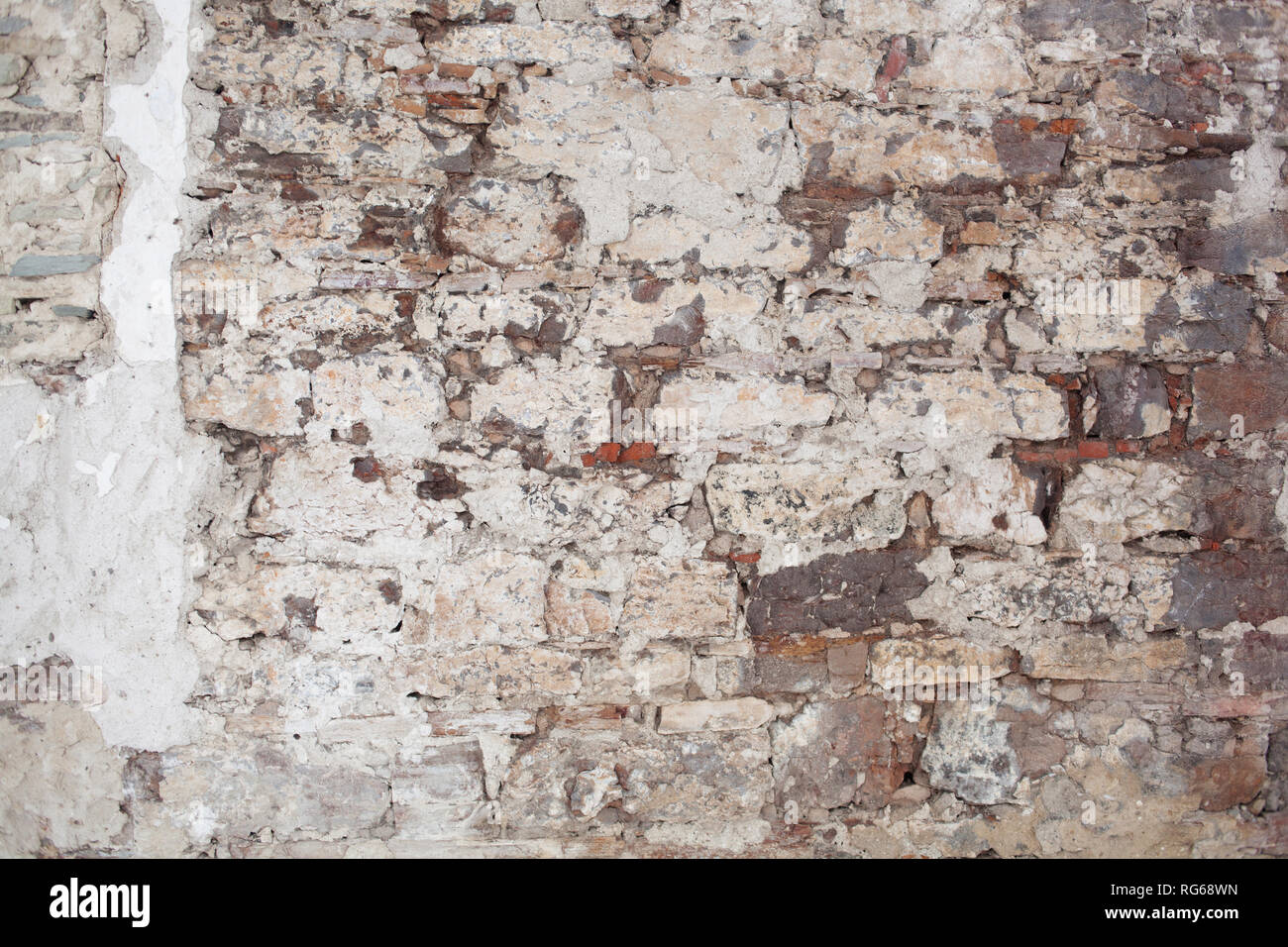 old medieval plaster and brick wall in shadow Stock Photo