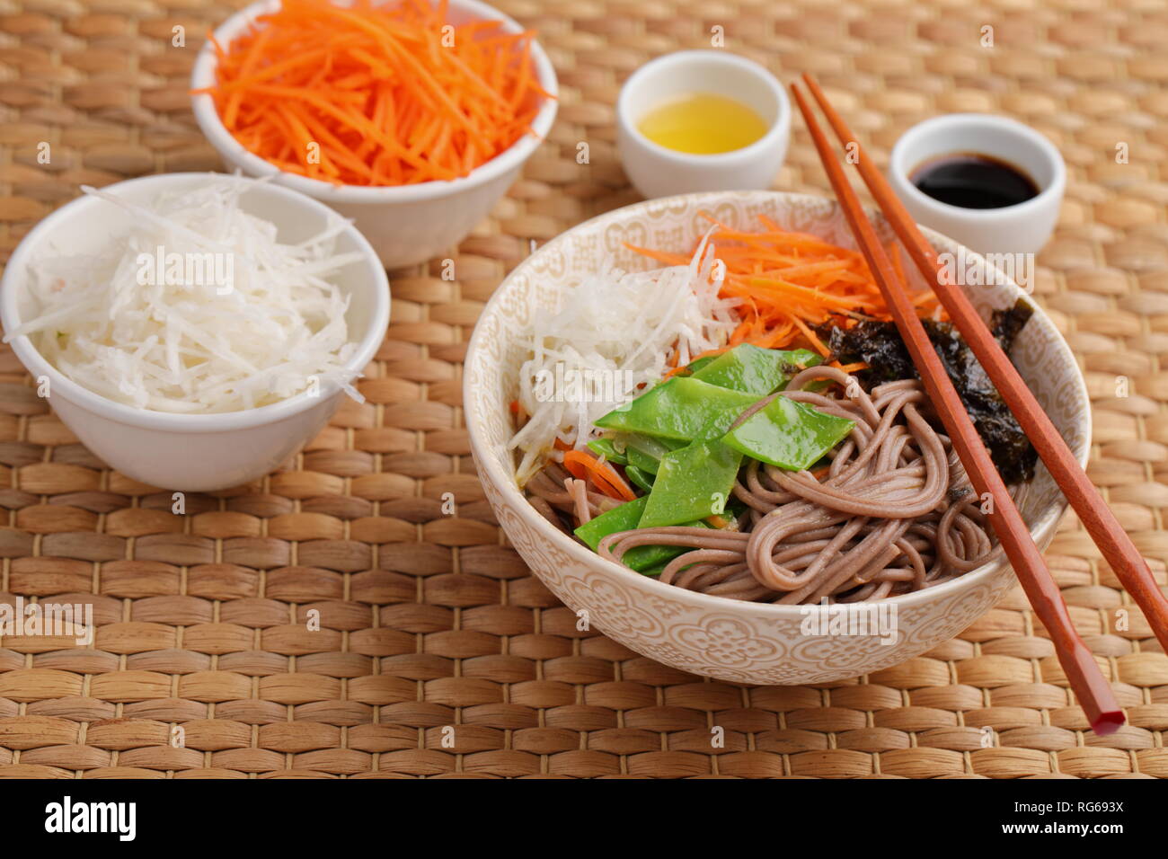 Soba noodle soup with nori seaweed sheets, green beans, carrot, daikon