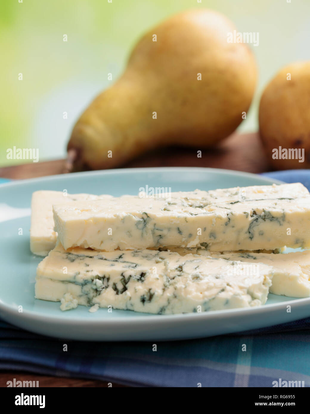 Sliced blue cheese and ripe fresh pears on a rustic table Stock Photo