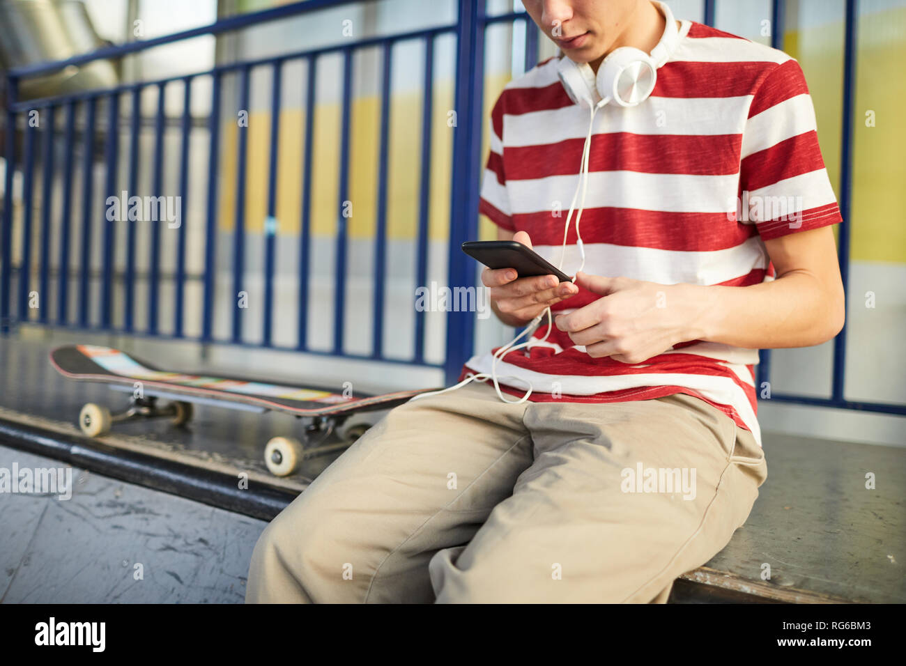 Teen skateboarder chilling Stock Photo