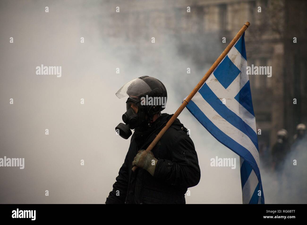 Greek man with Greek flag after tear gas in front of Parliament, during protest against recognition FYROM as North Macedonia. 20.01.2019 | usage worldwide Stock Photo